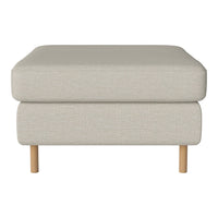 Light beige ottoman with a textured fabric finish and natural wood legs. Versatile and modern design for any space.