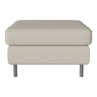 Light beige fabric ottoman with a smooth texture and modern silver legs, perfect for any contemporary living space.