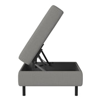 Gray upholstered storage bed with a textured pattern and sleek black legs, showcasing a modern design.