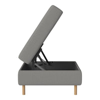 Gray upholstered storage bed with light wood legs, modern design and subtle textured pattern in a minimalist style.