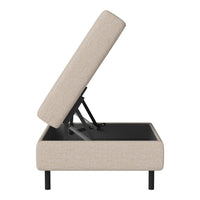 Beige upholstered ottoman with a modern minimalist style, featuring a smooth fabric and a sleek black base.