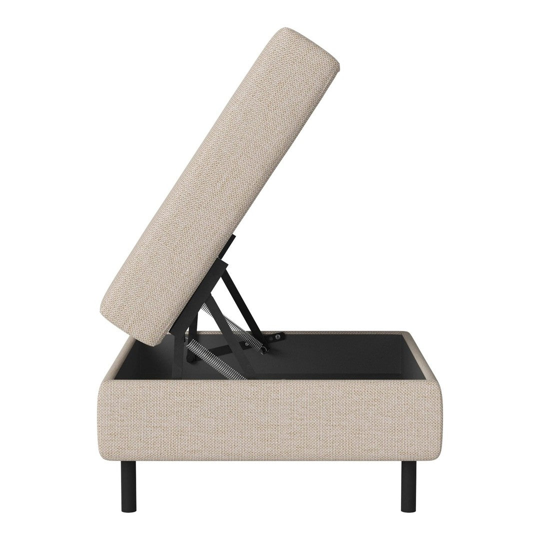 Beige upholstered lift-top storage ottoman with a sleek black base and minimalist design. Ideal for modern decor.
