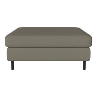 Gray upholstered ottoman with a sleek, minimalist design and black legs, perfect for modern decor.