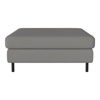 Gray upholstered ottoman with a smooth surface and understated pattern, complemented by sleek black legs.