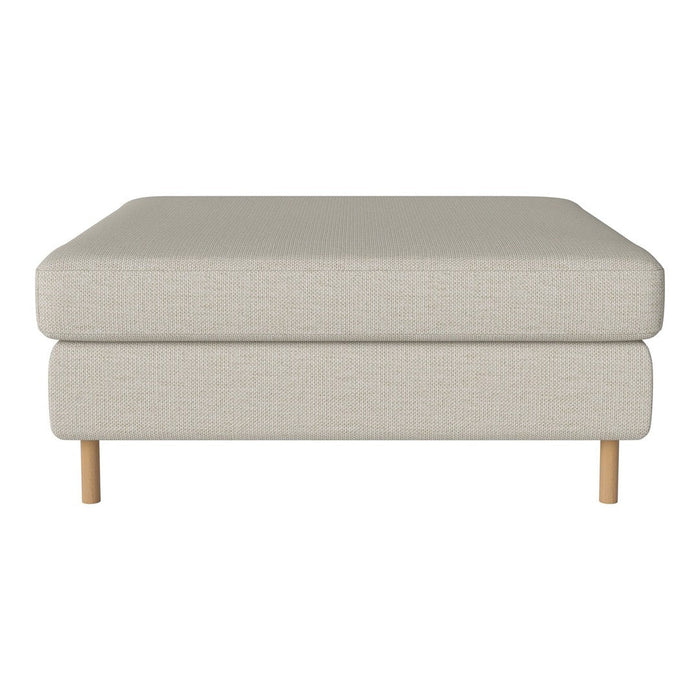 Light beige ottoman with a minimalist design and natural wood legs. Perfect for versatile decor styles.