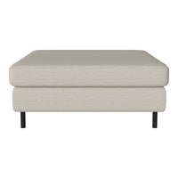 Light beige fabric ottoman with a smooth texture and black metal legs, ideal for modern decor.