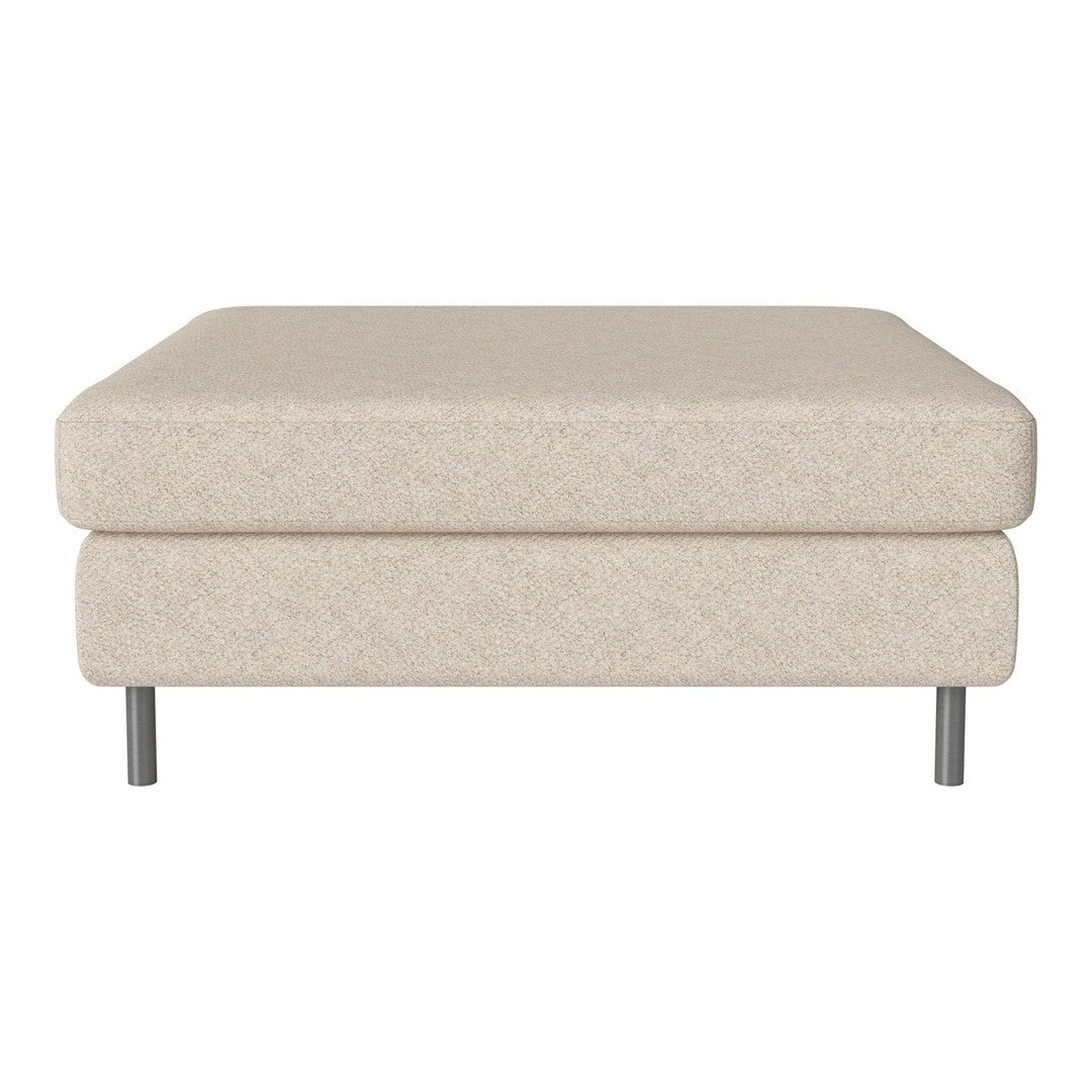 Beige upholstered ottoman with a smooth texture and minimalistic design, featuring silver legs for a modern touch.