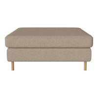 Beige upholstered ottoman with a minimalist design and natural wood legs. Soft, textured surface for modern decor.