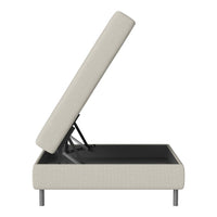 Cream upholstered storage bed with a sleek black interior and minimalist design elements. Modern and functional.