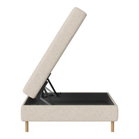 Light beige upholstered storage bed with wooden legs and a sleek black interior. Modern, minimalist design.