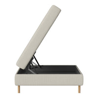 Beige upholstered sofa with a lift-top design and sleek black interior, showcasing natural wood legs.