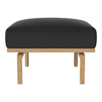 Black upholstered ottoman with a minimalist oak wood frame, showcasing a sleek modern design.