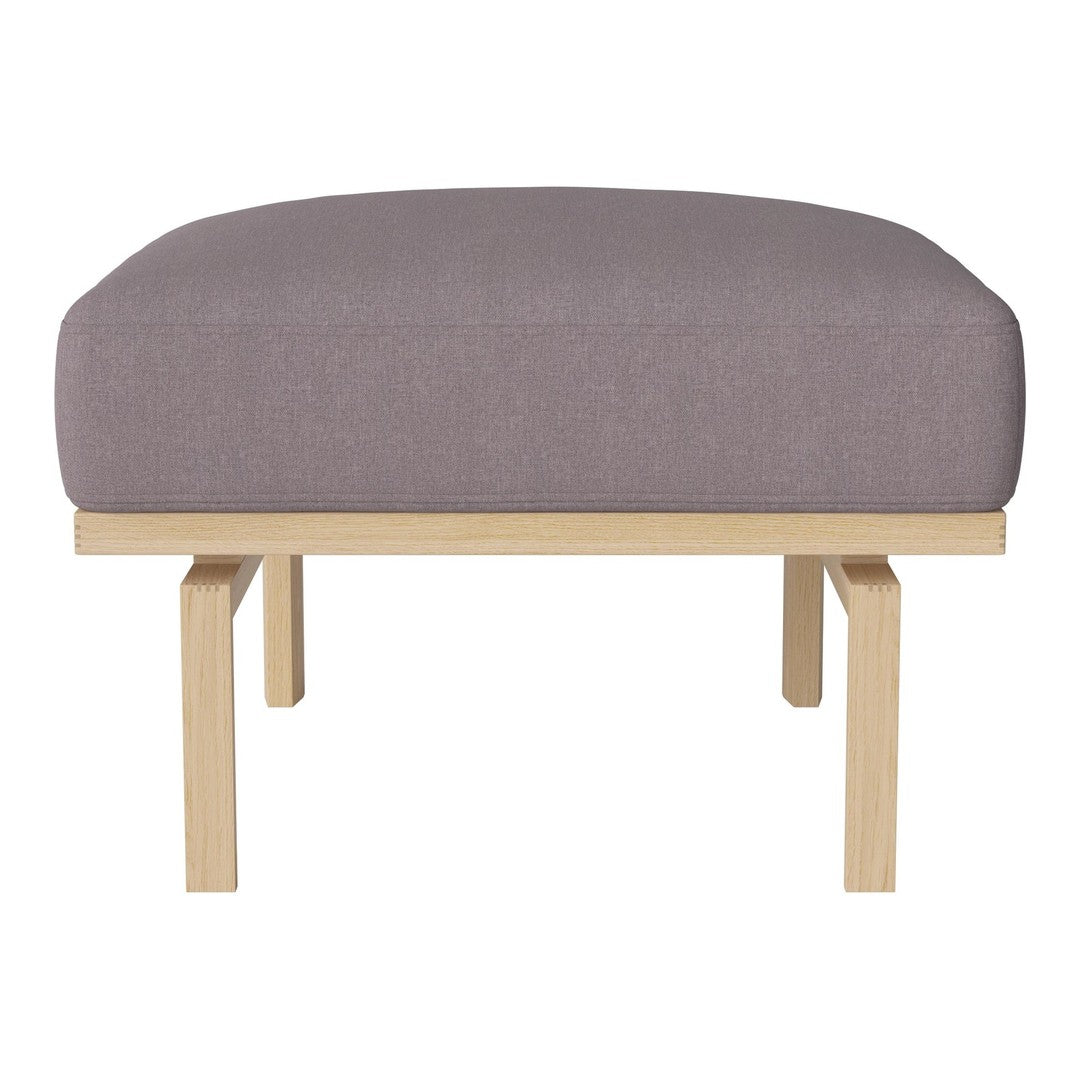 Purple upholstered ottoman with a minimalist wooden frame, showcasing a sleek, modern design. Perfect for any decor.