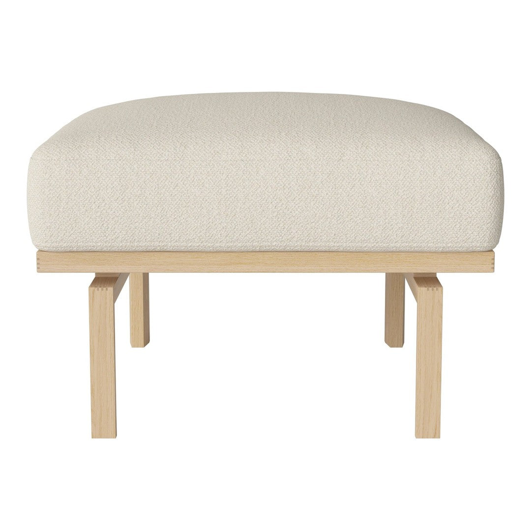 Cream upholstered ottoman with a simple, modern design and natural wood legs. Ideal for any contemporary space.