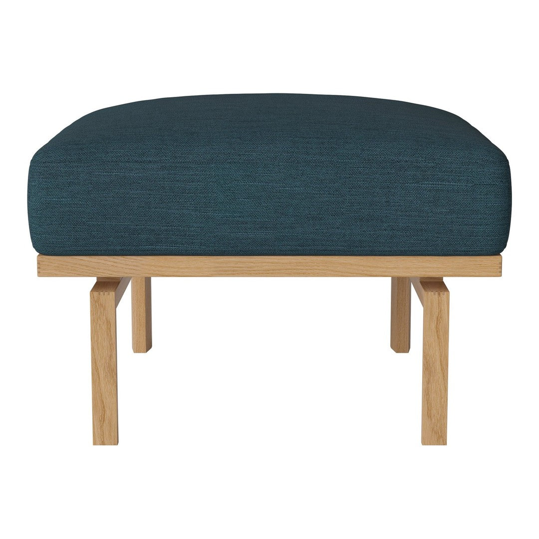 Teal upholstered ottoman with a textured finish and natural wood legs, featuring a modern, minimalist design.
