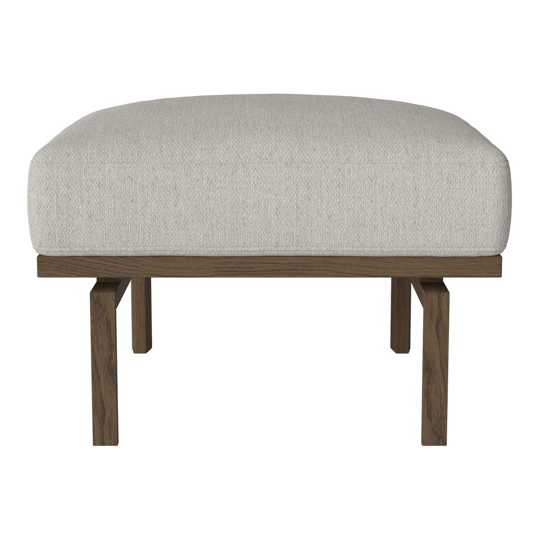 Light gray upholstered ottoman with a smooth texture and dark wood legs, offering a minimalist, modern design.