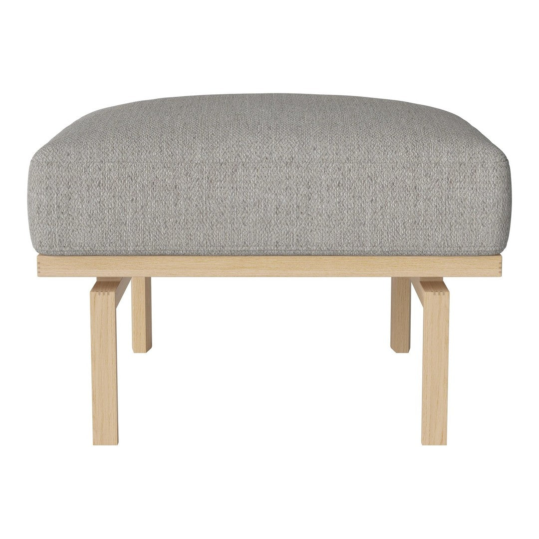 Gray upholstered ottoman with a minimalist wooden base, featuring a smooth, solid color pattern.