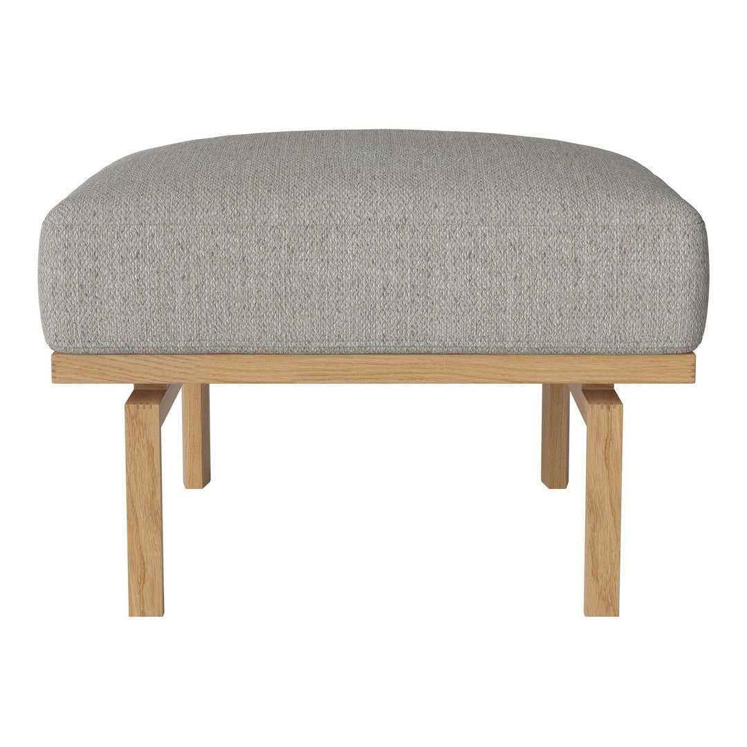 Gray upholstered ottoman with a textured pattern, complemented by a light wood frame. Modern and stylish design.