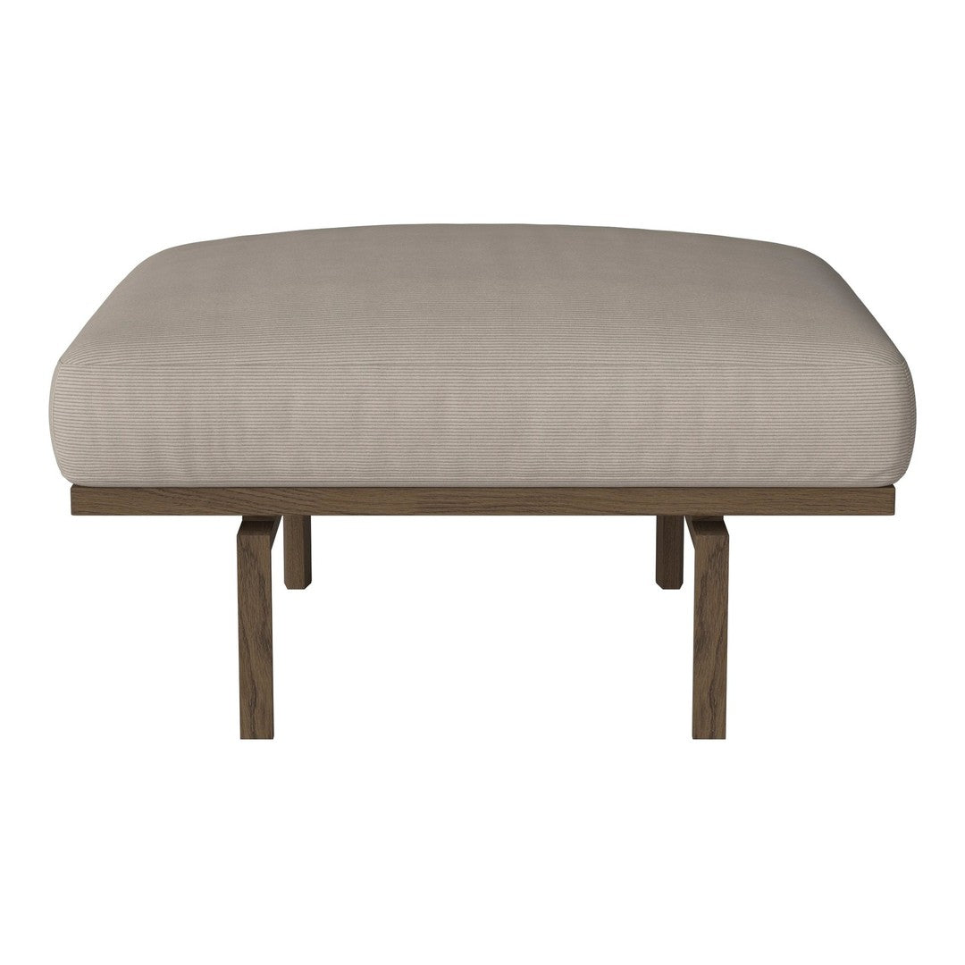 Beige upholstered stool with a smooth, solid surface and wooden legs. Minimalist design perfect for modern decor.