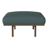 Teal upholstered chair with a textured fabric, featuring a natural wood frame and simple, modern design.