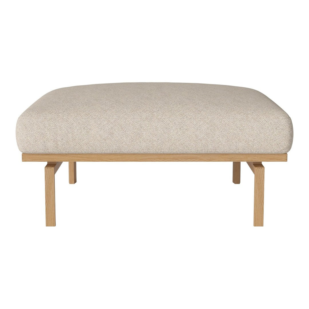Cream fabric upholstered ottoman with a smooth, textured surface and natural wood legs. Minimalist and modern design.