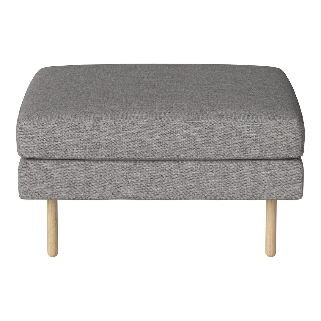 Gray upholstered ottoman with a minimalist design and light wooden legs. Simple, modern, and stylish accent piece.