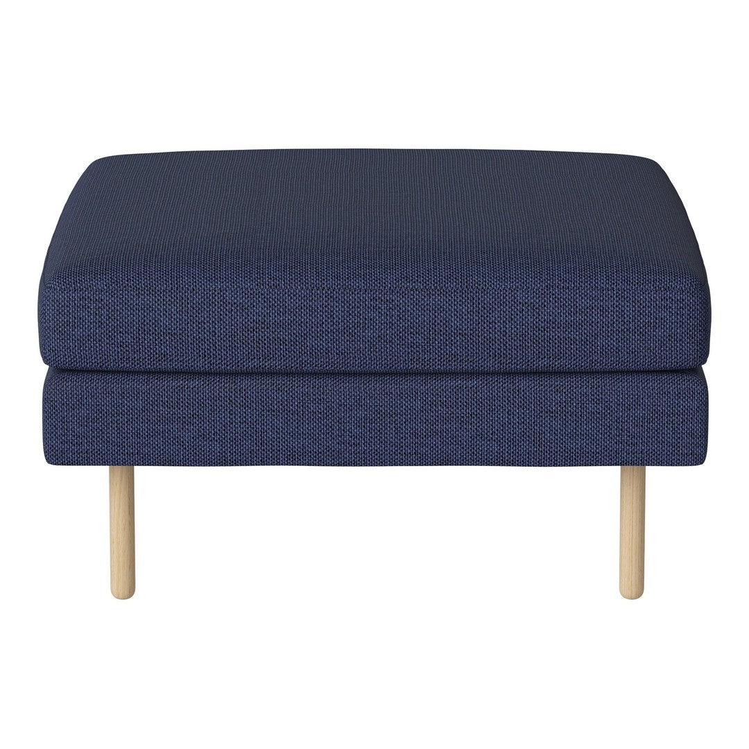 Navy blue ottoman with a textured fabric and natural wood legs. Simple, modern design perfect for any space.