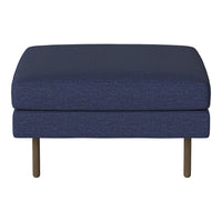 Navy blue ottoman with a textured pattern and sleek metal legs, perfect for modern home decor.