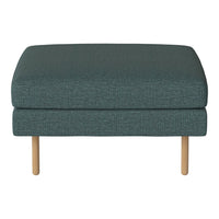 Teal upholstered ottoman with textured fabric and light wooden legs, perfect for modern home decor.