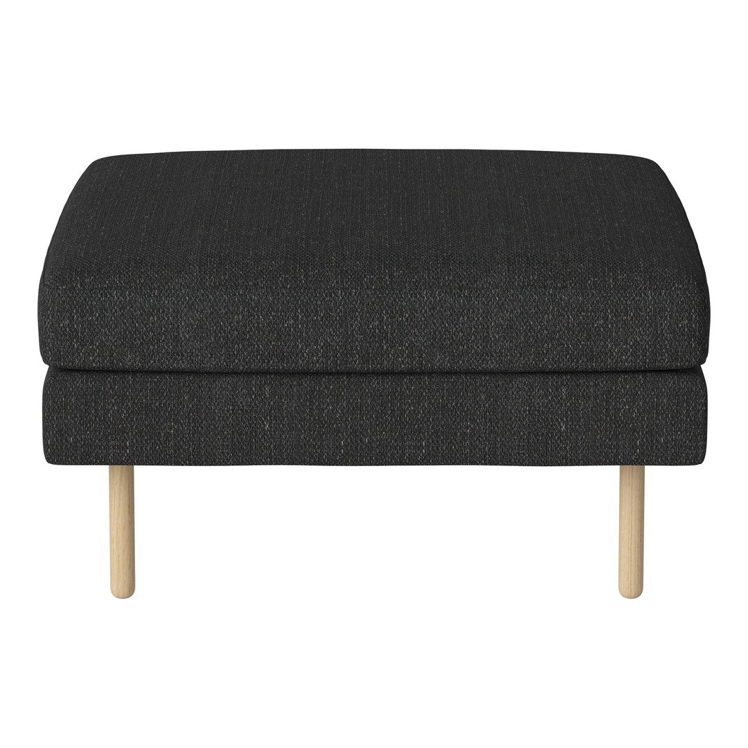 Black textured ottoman with natural wood legs, offering a modern and sleek look for any living space.