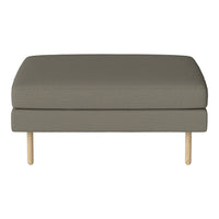 Olive green upholstered ottoman with a smooth texture and light wooden legs. Simple, modern design.