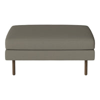 "Neutral gray upholstery ottoman with a smooth texture and minimalist design, complemented by slender wooden legs."