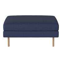 Navy blue upholstered ottoman with a solid pattern and natural wood legs, ideal for modern living spaces.