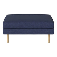 Navy blue upholstered ottoman with a textured fabric and natural wooden legs, adding a modern touch to any space.