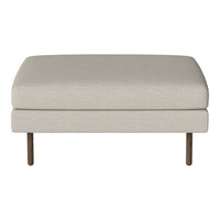 Beige upholstered ottoman with a smooth, solid surface and wooden legs, perfect for adding a neutral touch to any space.