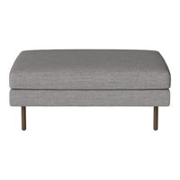 Gray upholstered ottoman with a sleek design and subtle texture, featuring minimalist metal legs.