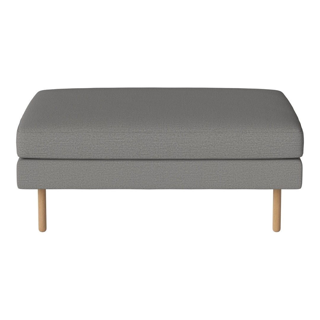 Gray upholstered ottoman with textured fabric and natural wood legs, ideal for modern decor.