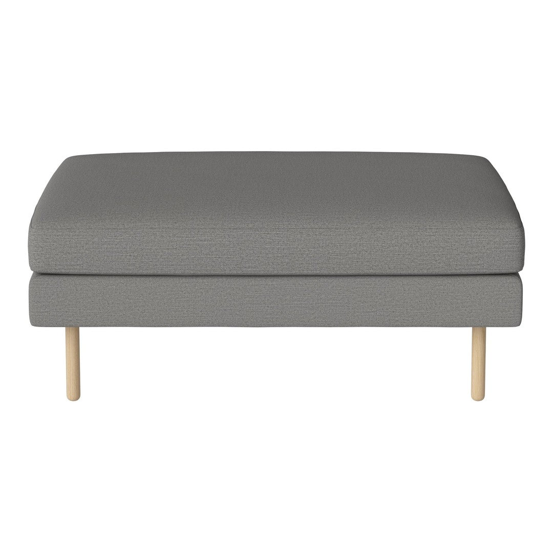 Gray upholstered ottoman with a subtle texture and light wooden legs, perfect for modern decor.