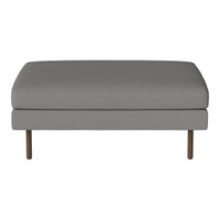 Gray upholstered ottoman with a smooth texture and minimalistic design, featuring metal legs for modern aesthetics.