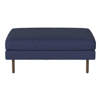 "Deep navy blue upholstered ottoman with textured fabric and sleek metal legs."