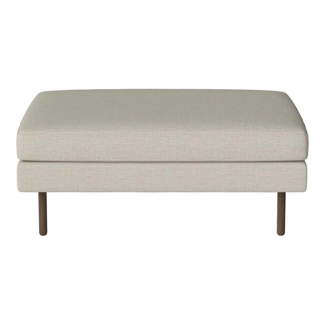 Light beige upholstered ottoman with a smooth texture and simple design, featuring slim wooden legs.