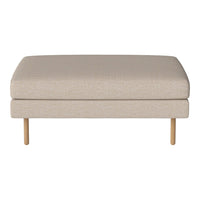 Beige upholstered ottoman with a simple, textured fabric and natural wood legs. Modern, minimalist design.