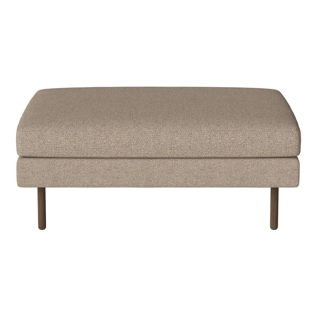 Tan upholstered ottoman with a smooth texture and minimalist design, featuring sturdy metal legs.