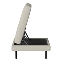 Beige upholstered bed frame with a minimalist design and sleek black legs, showcasing a textured pattern.