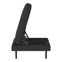 Black adjustable sofa bed with a textured fabric pattern, showcasing a sleek and modern design.