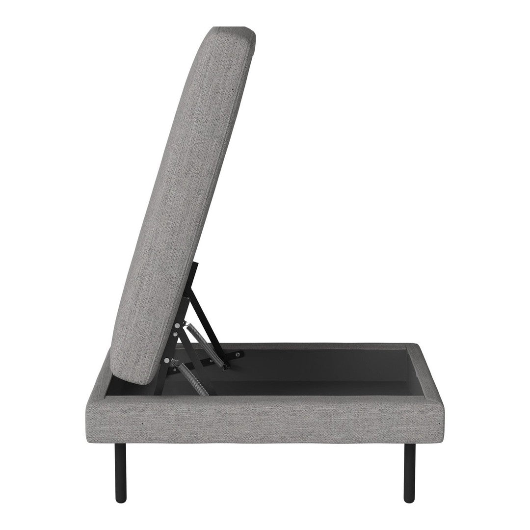 Grey upholstered adjustable bed with a minimalist design and sleek black base. Ideal for modern interiors.