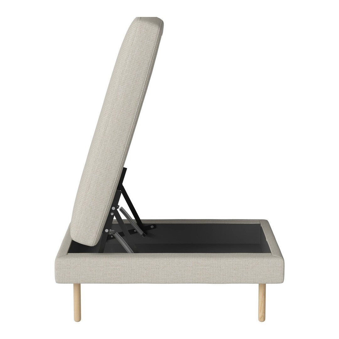 Light beige upholstered ottoman with a sleek, textured fabric and natural wood legs. Simple, modern design.