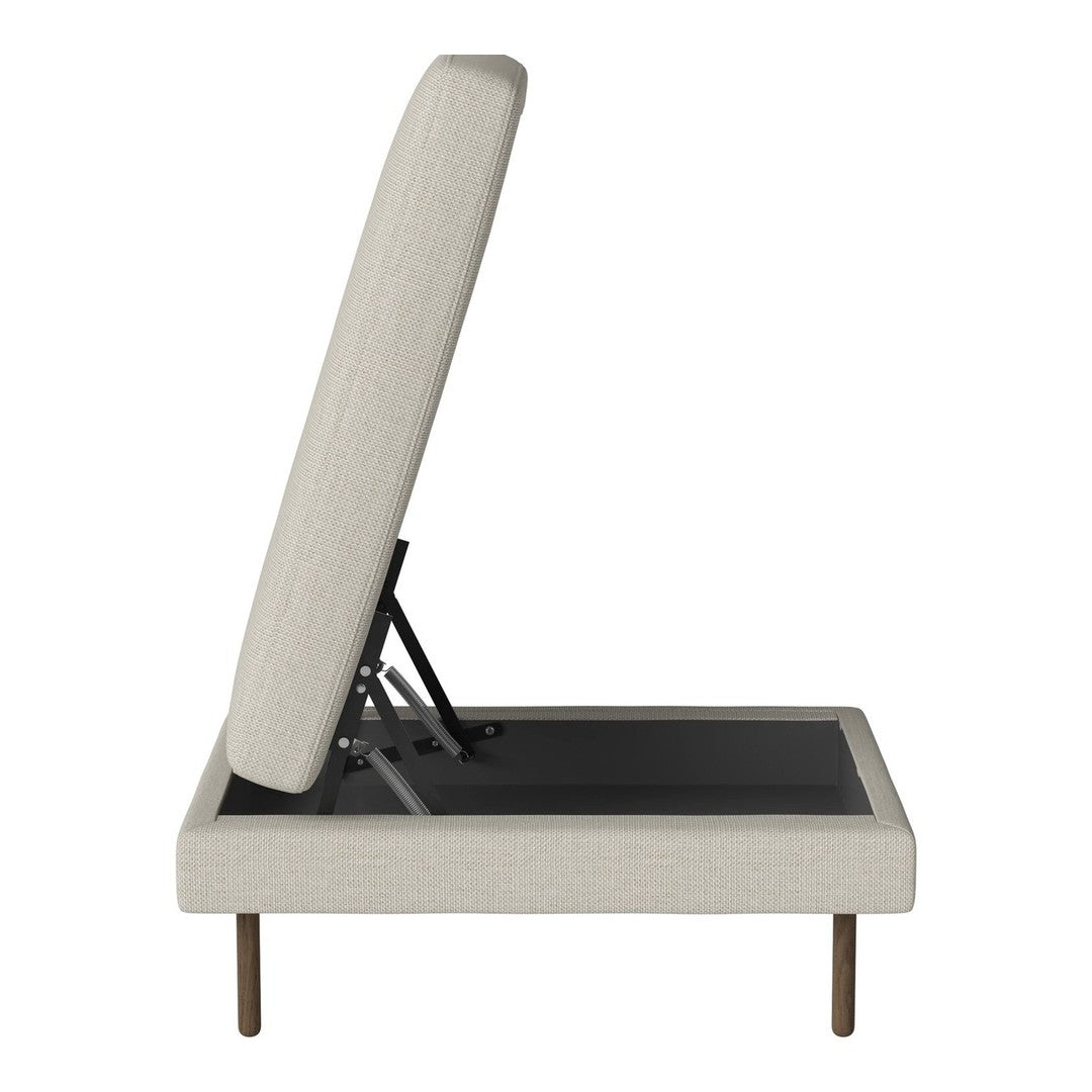 Cream-colored upholstered storage bed with a textured finish and sleek black base. Modern and minimalist design.