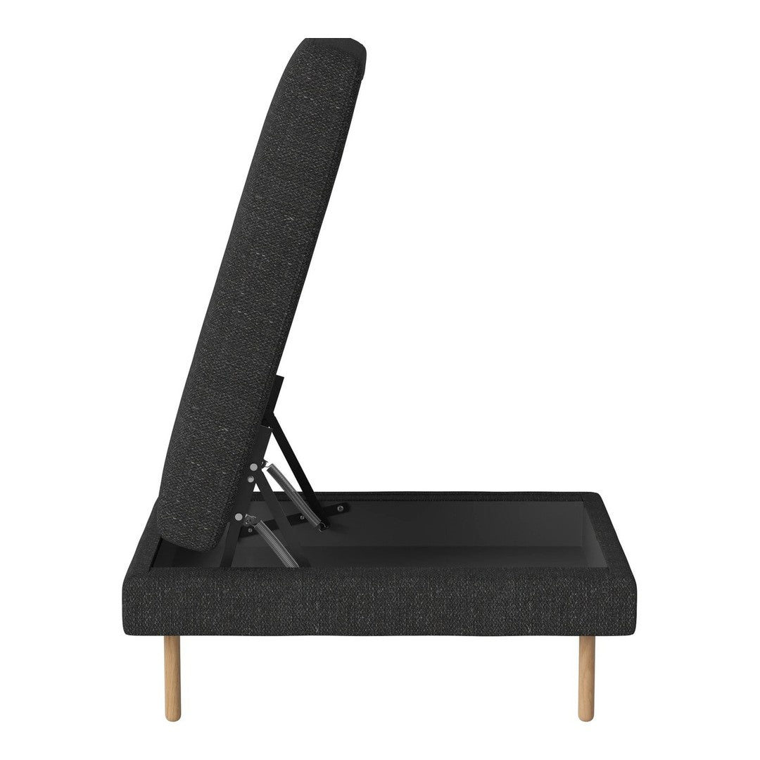 Modern dark gray chaise lounge with clean lines and natural wood legs, featuring a minimalist, textured fabric design.