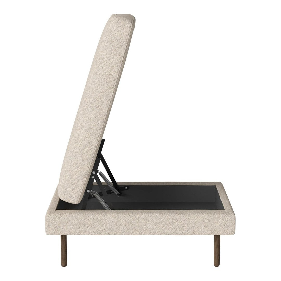 Beige upholstered ottoman with a textured fabric and sleek black detailing. Modern design with metal legs.